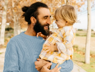 Smiling Father Holding Child