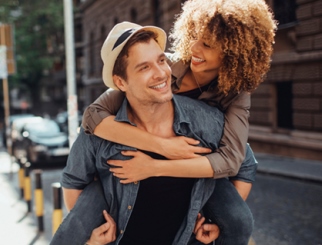 Two Young Adults hugging.