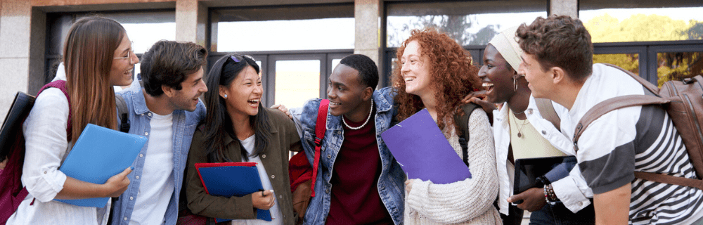 Diverse group of students smiling on a college campus