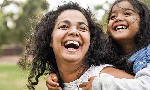 Happy and smiling mother with child at the park