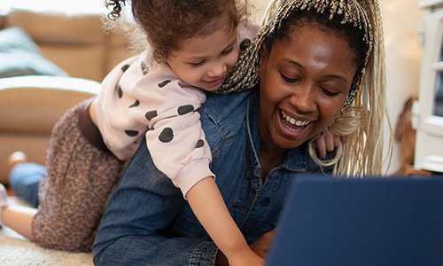 Happy woman and child looking at a computer screen