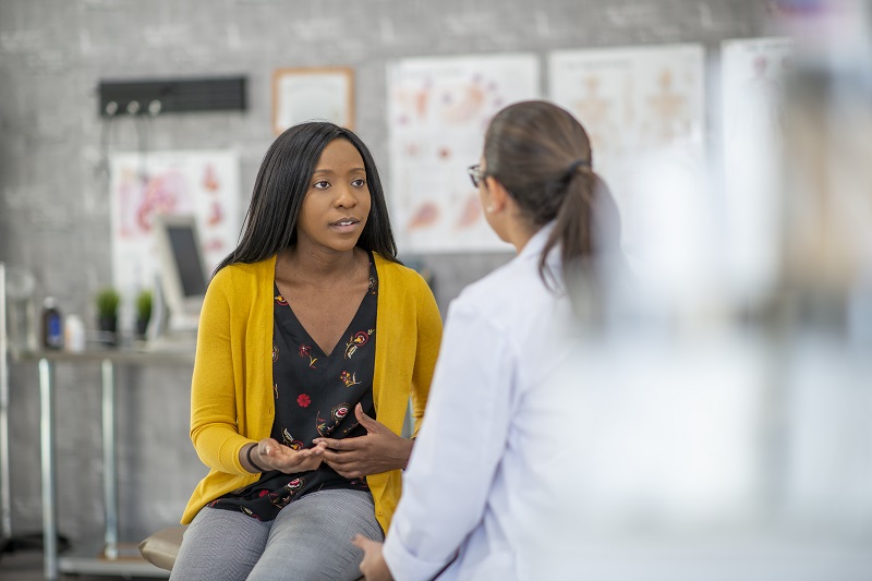 A woman speaking with the doctor while at an appointment