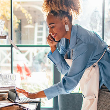 Woman working at shop on phone